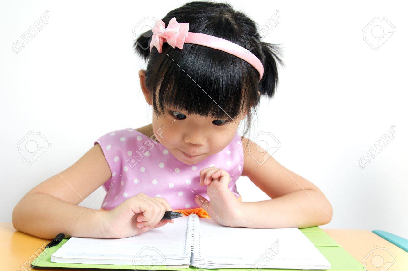 Little kid is looking at her book surprisingly - 14471006 Little kid is looking at her book surprisingly - 14471006