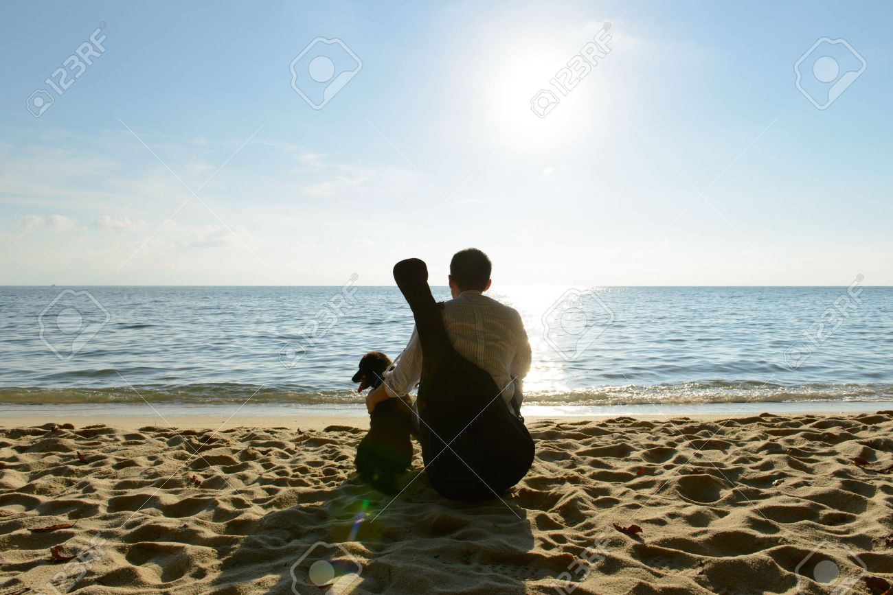 Lonely man with his dog and guitar at beach - 18810392 Lonely man with his dog and guitar at beach - 18810392
