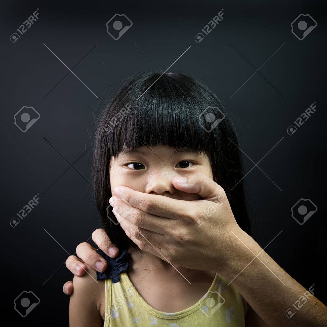 Asian Child Being Kidnapped, With Mouth Covered By An Adult Hand Stock  Photo, Picture and Royalty Free Image. Image 44348477.