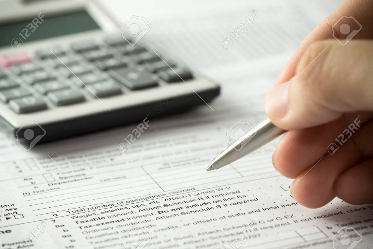 US individual income tax return form with pen and calculator - 55619036 US individual income tax return form with pen and calculator - 55619036
