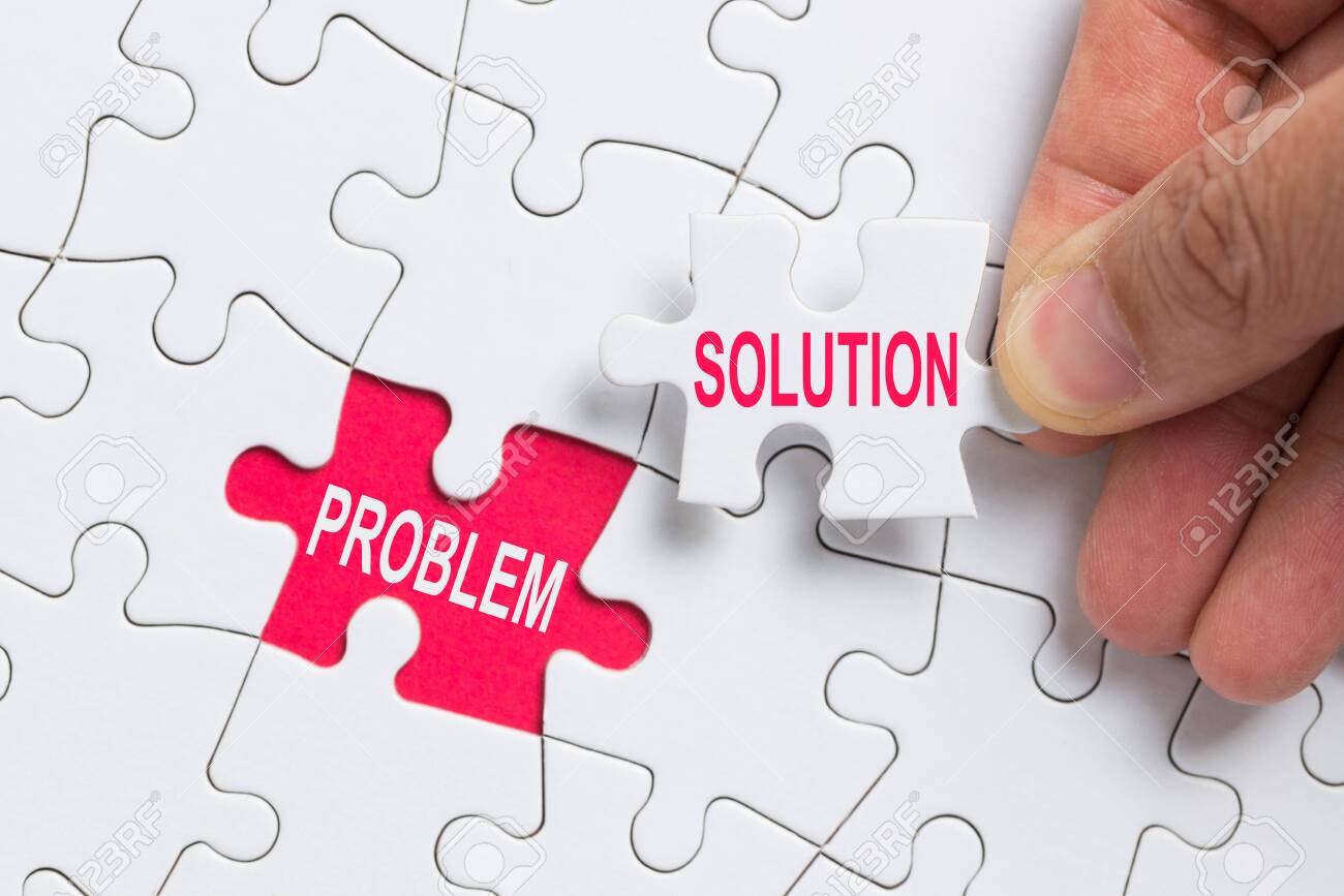 Hand holding piece of white jigsaw puzzle with word problem and solution. - 122570408 Hand holding piece of white jigsaw puzzle with word problem and solution. - 122570408