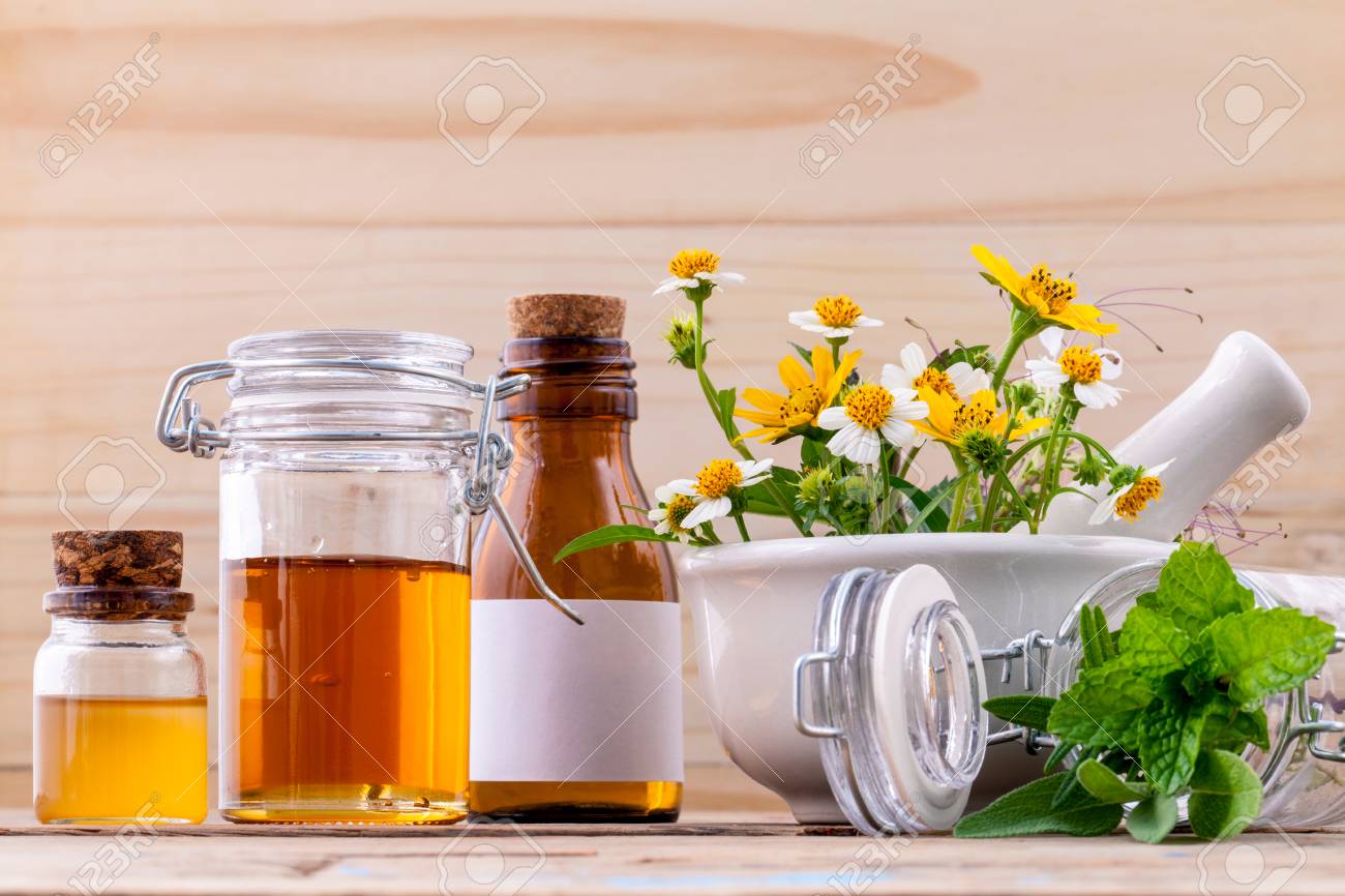 Alternative health care fresh herbal ,honey and wild flower with mortar on wooden background. - 48355391 Alternative health care fresh herbal ,honey and wild flower with mortar on wooden background. - 48355391