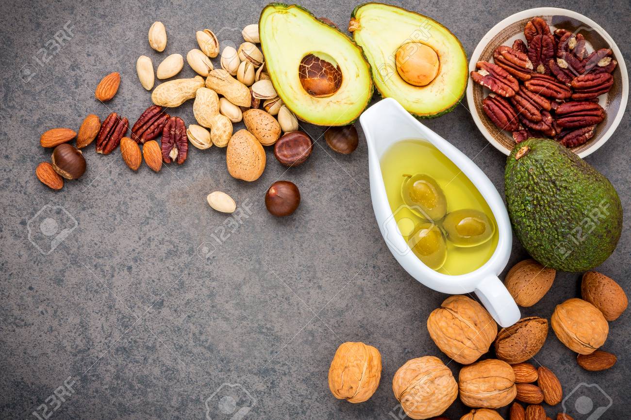 Selection food sources of omega 3 and unsaturated fats. Superfood high vitamin e and dietary fiber for healthy food. Almond ,pecan,hazelnuts,walnuts,olive oil,fish oil and salmon on stone background. - 87324213 Selection food sources of omega 3 and unsaturated fats. Superfood high vitamin e and dietary fiber for healthy food. Almond ,pecan,hazelnuts,walnuts,olive oil,fish oil and salmon on stone background. - 87324213