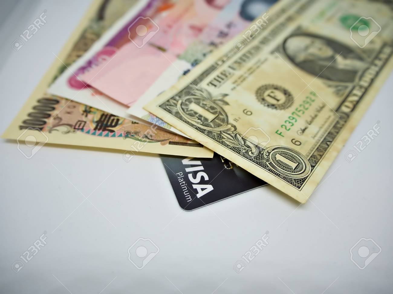 Bangko, Thailand - 2018 September 01 : A Variety Of Currency Incluing  Japanese Yen, Myanmar Kyat, Thai Baht, Chinese Yuan And US Dollar Stacking  Over Visa Platinum Card Stock Photo, Picture and
