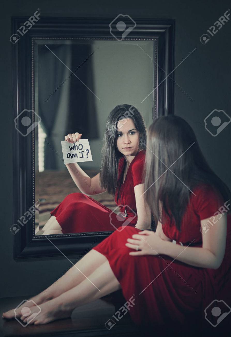 A woman looking into a mirror and asking \"who am I?\" - 36874142 A woman looking into a mirror and asking \"who am I?\" - 36874142