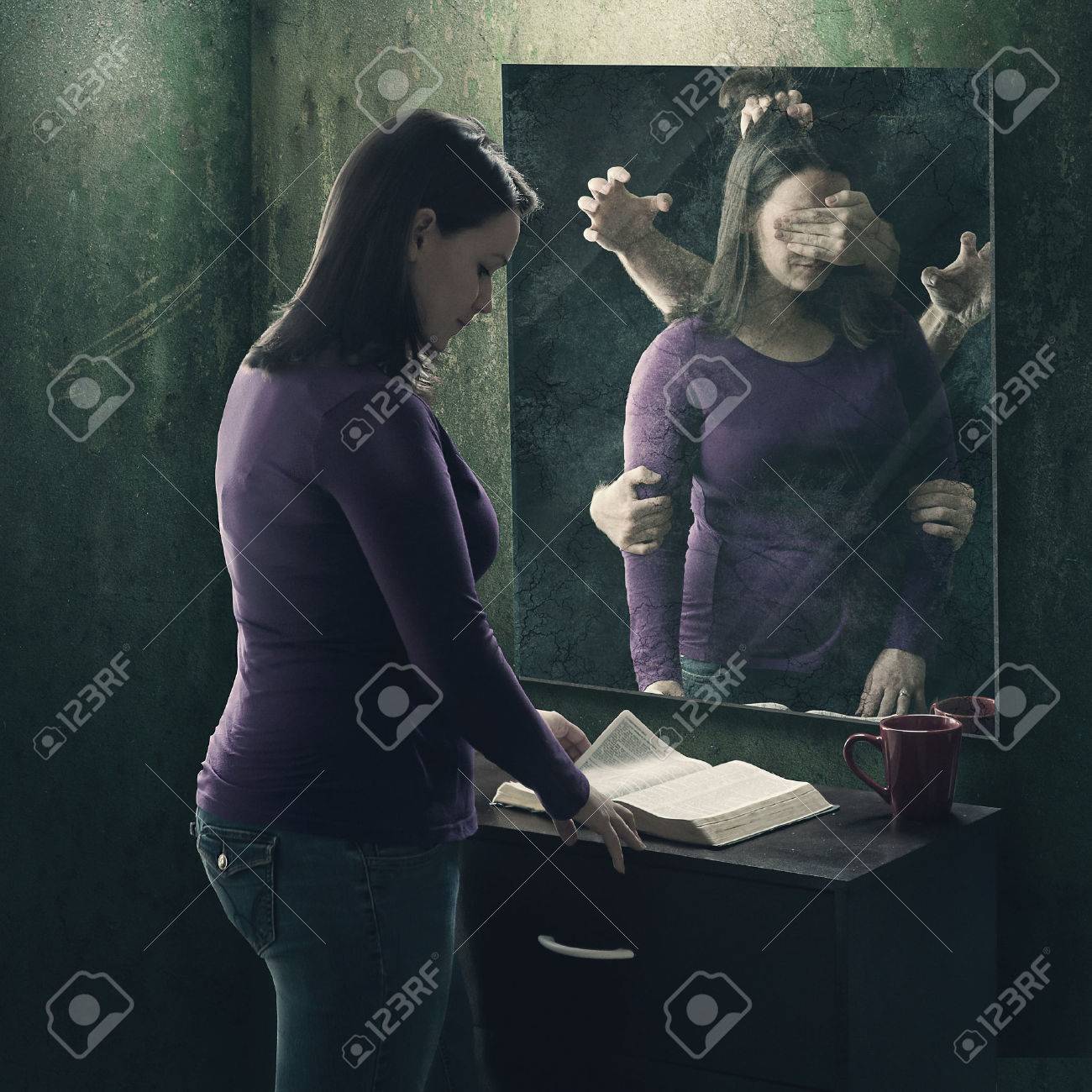 A woman reads her Bible as demons try to stop her - 57203779 A woman reads her Bible as demons try to stop her - 57203779