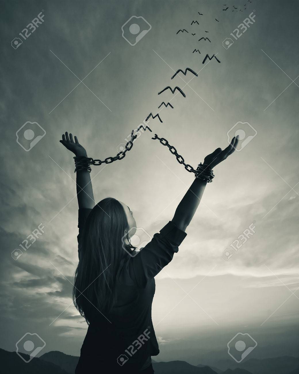 A woman breaks her chains as the links turn into freedom birds - 81659701 A woman breaks her chains as the links turn into freedom birds - 81659701