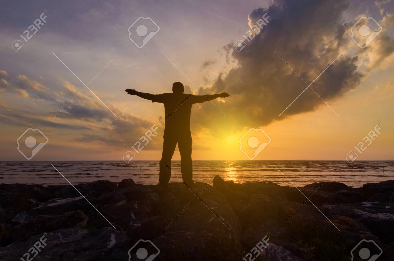 Silhouette Dun Homme Près De La Mer à Regarder Un Coucher De Soleil Dor