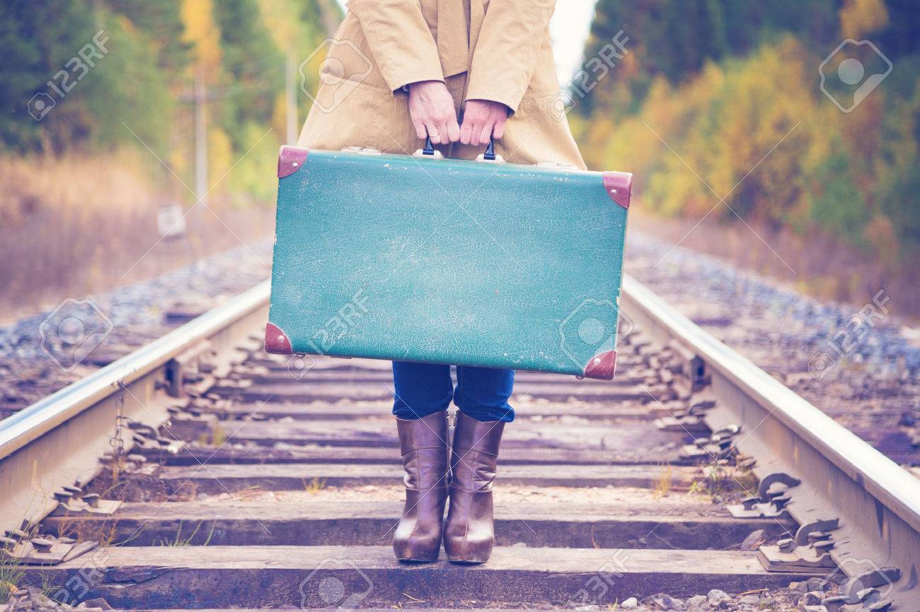 Elegant woman with a suitcase traveling by rail autumn day. - 50407164 Elegant woman with a suitcase traveling by rail autumn day. - 50407164