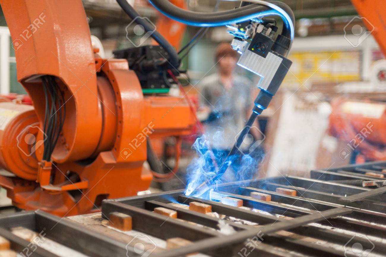 Welder robot operate in steel factory - 58876379 Welder robot operate in steel factory - 58876379