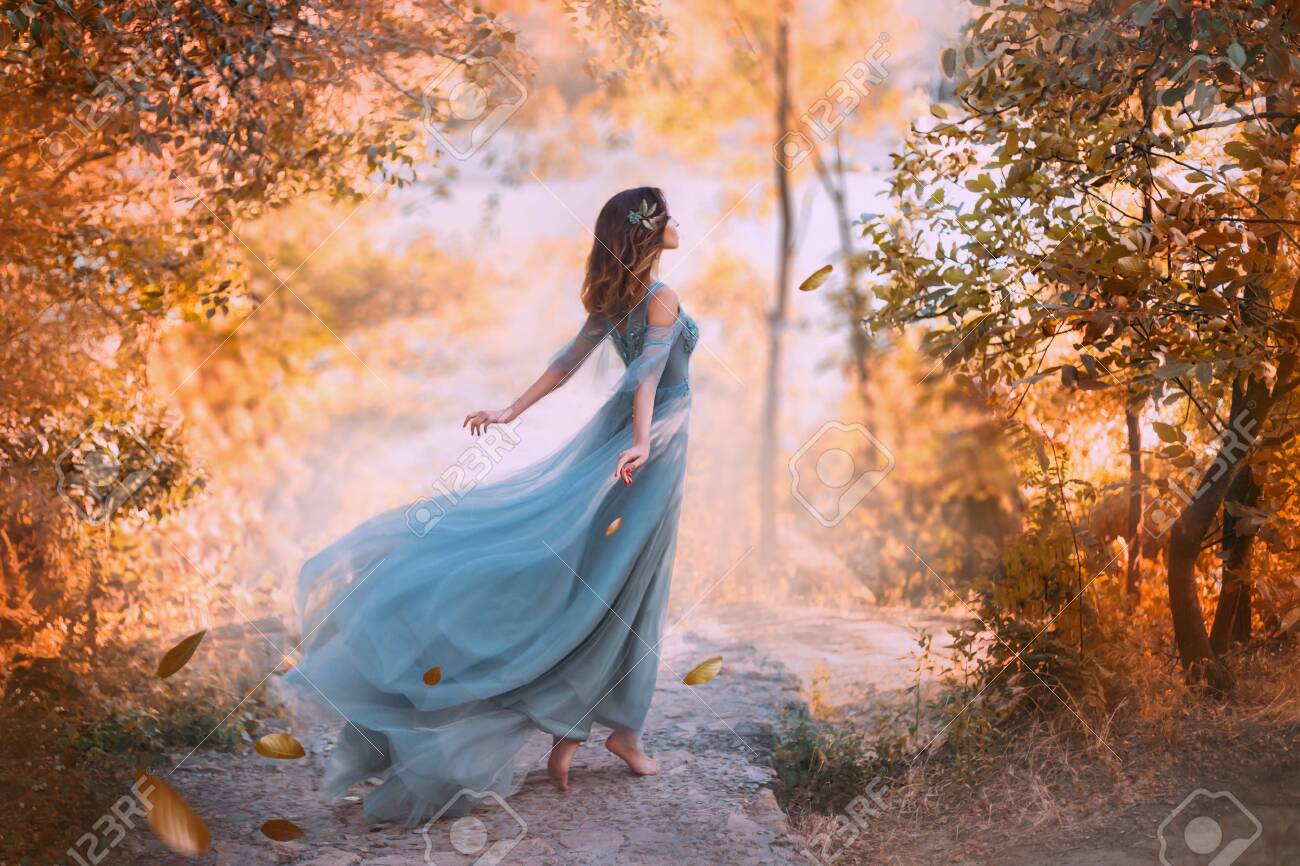 Beautiful woman wearing blue turquoise dress in the forest - 127487610 Beautiful woman wearing blue turquoise dress in the forest - 127487610