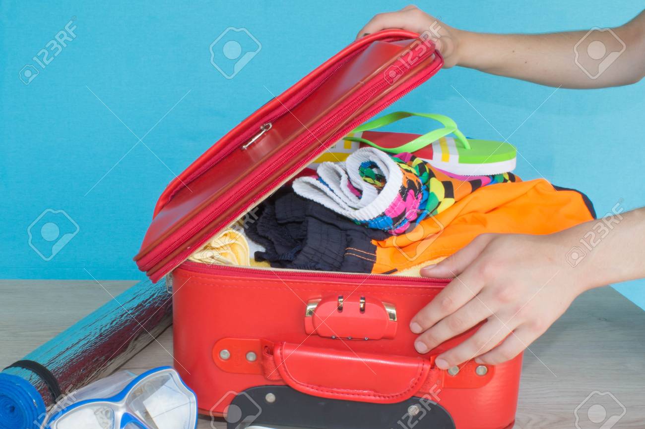 Woman Hands Packing Her Red Suitcase. Travel And Vacations Concept. Open  Traveler's Bag With Clothing, Accessories Фотография, картинки, изображения  и сток-фотография без роялти. Image 83223870
