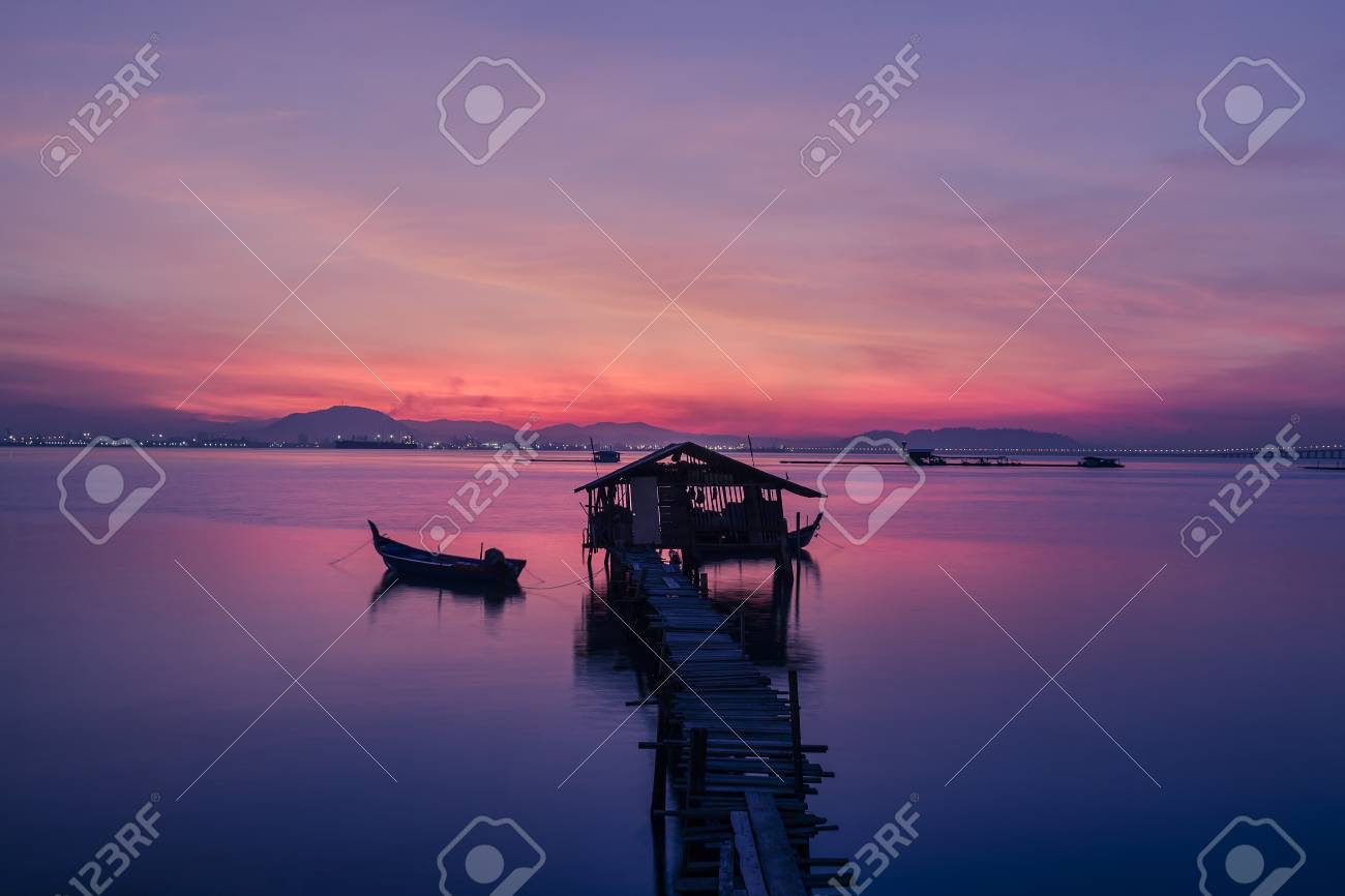 fisherman s cottage and pier at sunrise stock photo picture and