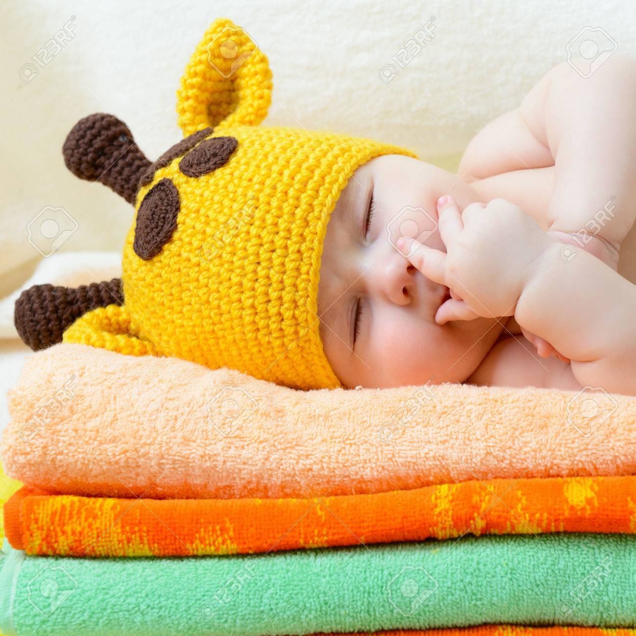 Cute Sleeping Baby Boy In Funny Hand Made Giraffe Hat Beautiful Kid Dozing On Pile Cute Sleeping Baby Boy In Funny Hand Made Giraffe Hat Beautiful Kid Dozing On Pile
