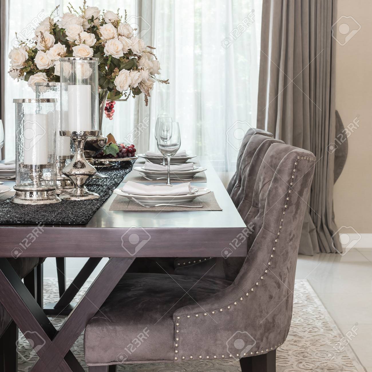 Salle à manger de luxe avec table en bois et chaise de style classique sur tapis Salle à manger de luxe avec table en bois et chaise de style classique sur tapis