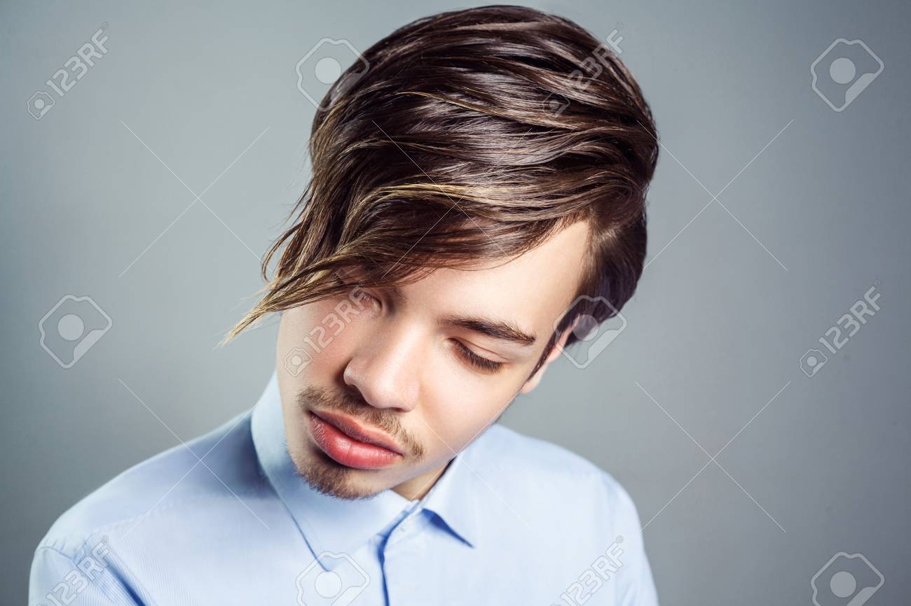 Portrait Of Young Man With Long Fringe Hairstyle On His Eyes