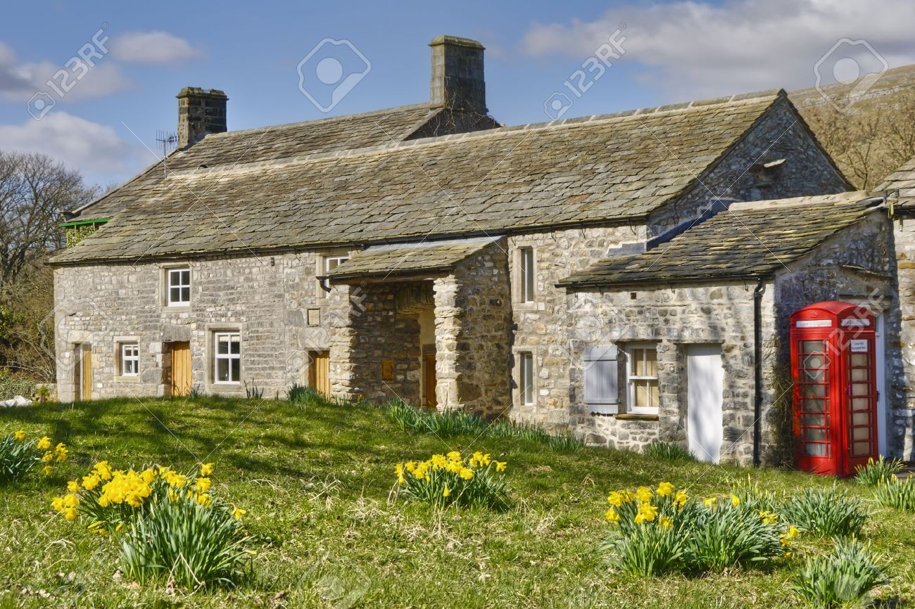 Exterior Of Stone Cottage In Countryside With Red Telephone Box Exterior Of Stone Cottage In Countryside With Red Telephone Box