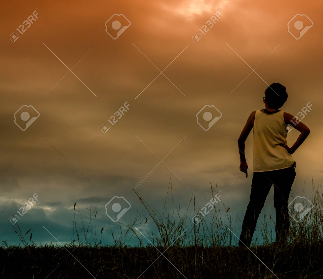 Silhouette Of The Woman Standing Lonely At The Field During Beautiful  Sunset Stock Photo, Picture and Royalty Free Image. Image 45960663., image size:1300x1123