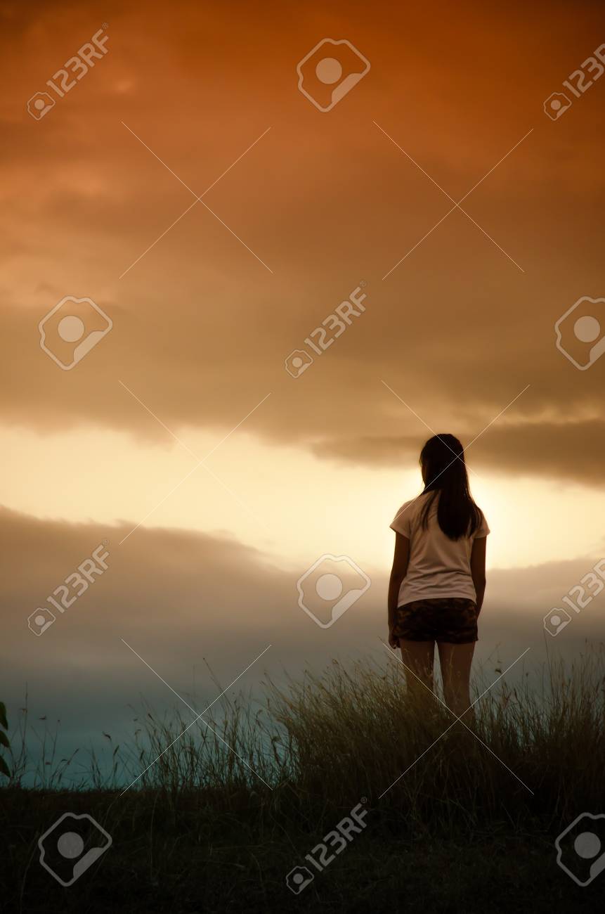 Woman Standing Alone At The Field During Beautiful Sunset Stock Photo,  Picture and Royalty Free Image. Image 45960672., image size:861x1300