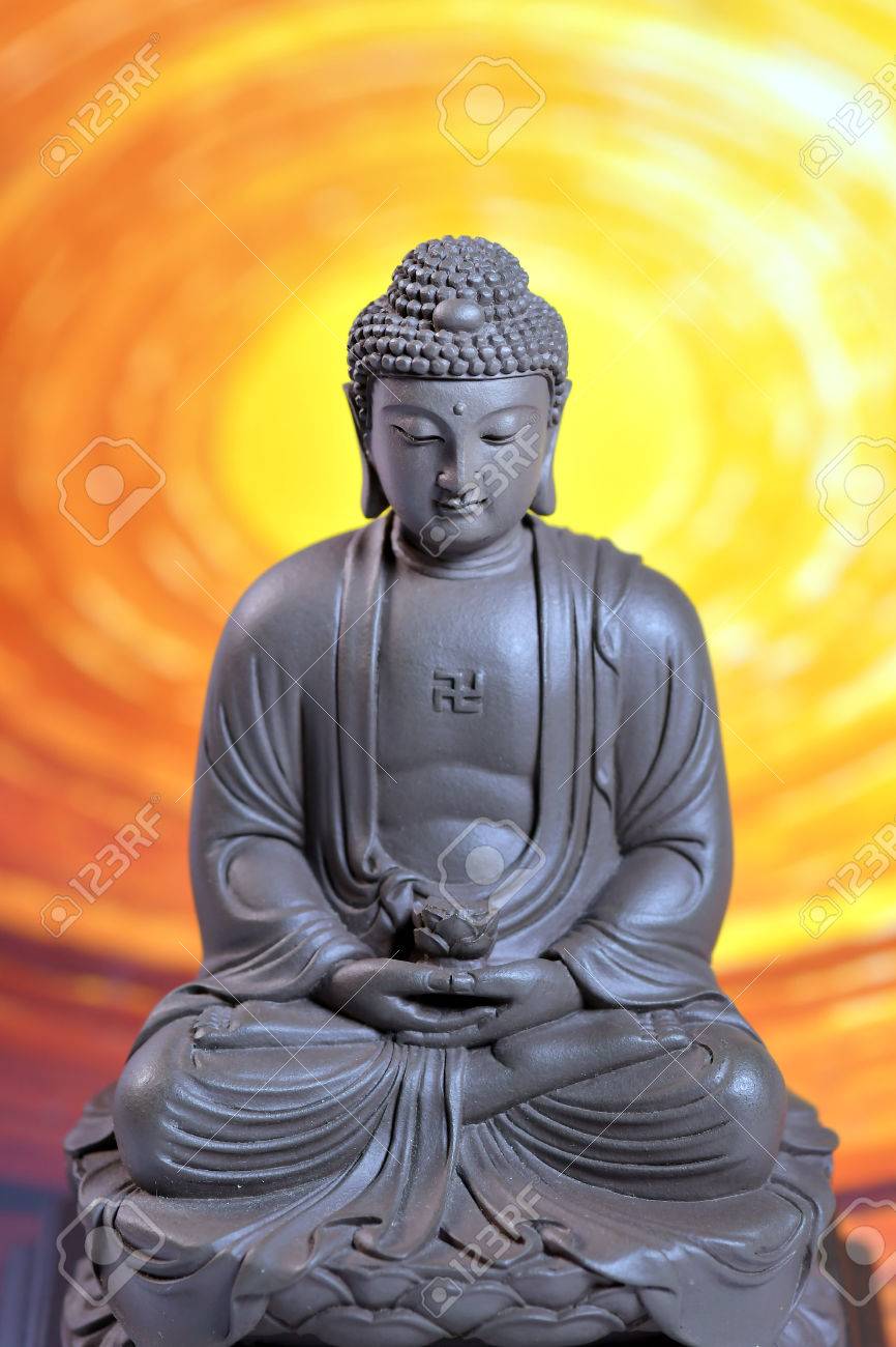 Zen Buddha Sculpture On The Yellow Background Stock Photo Picture And Royalty Free Image Image