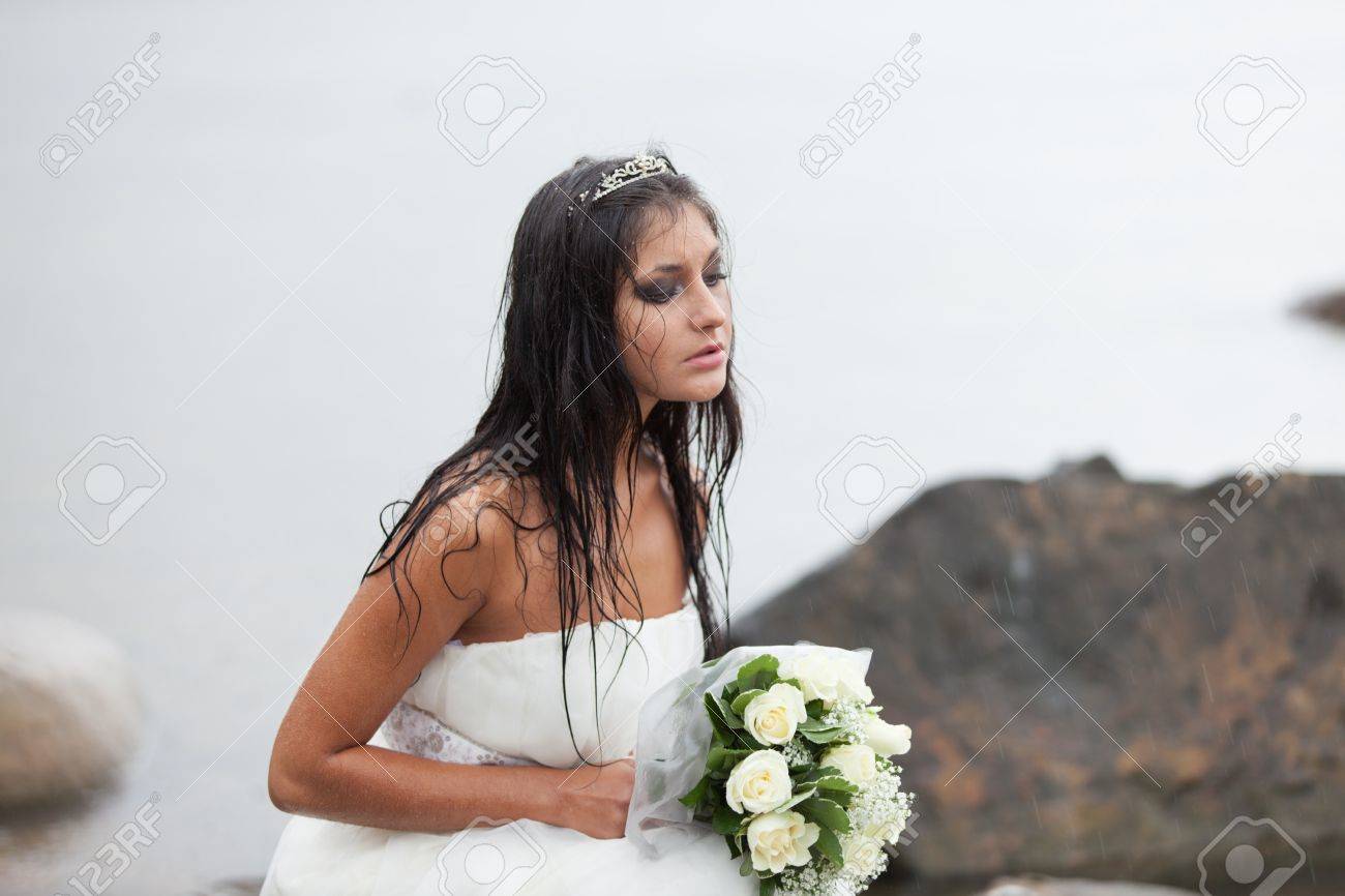 Sad Bride Sitting On The Sea-shore And Crying In The Rain Stock Photo,  Picture and Royalty Free Image. Image 14581109., image size:1300x866