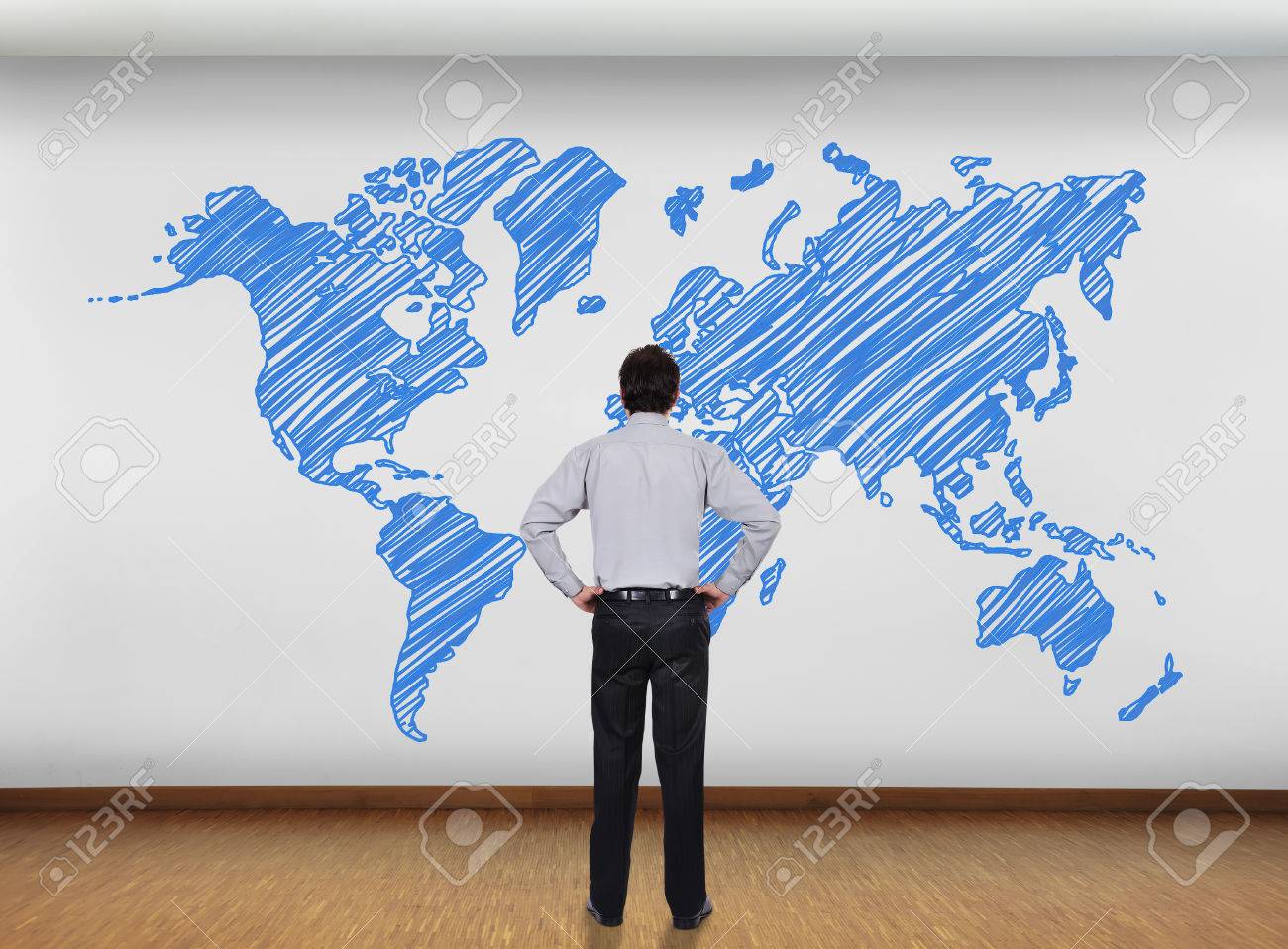 businessman in office looking at wall with world map stock photo office world map