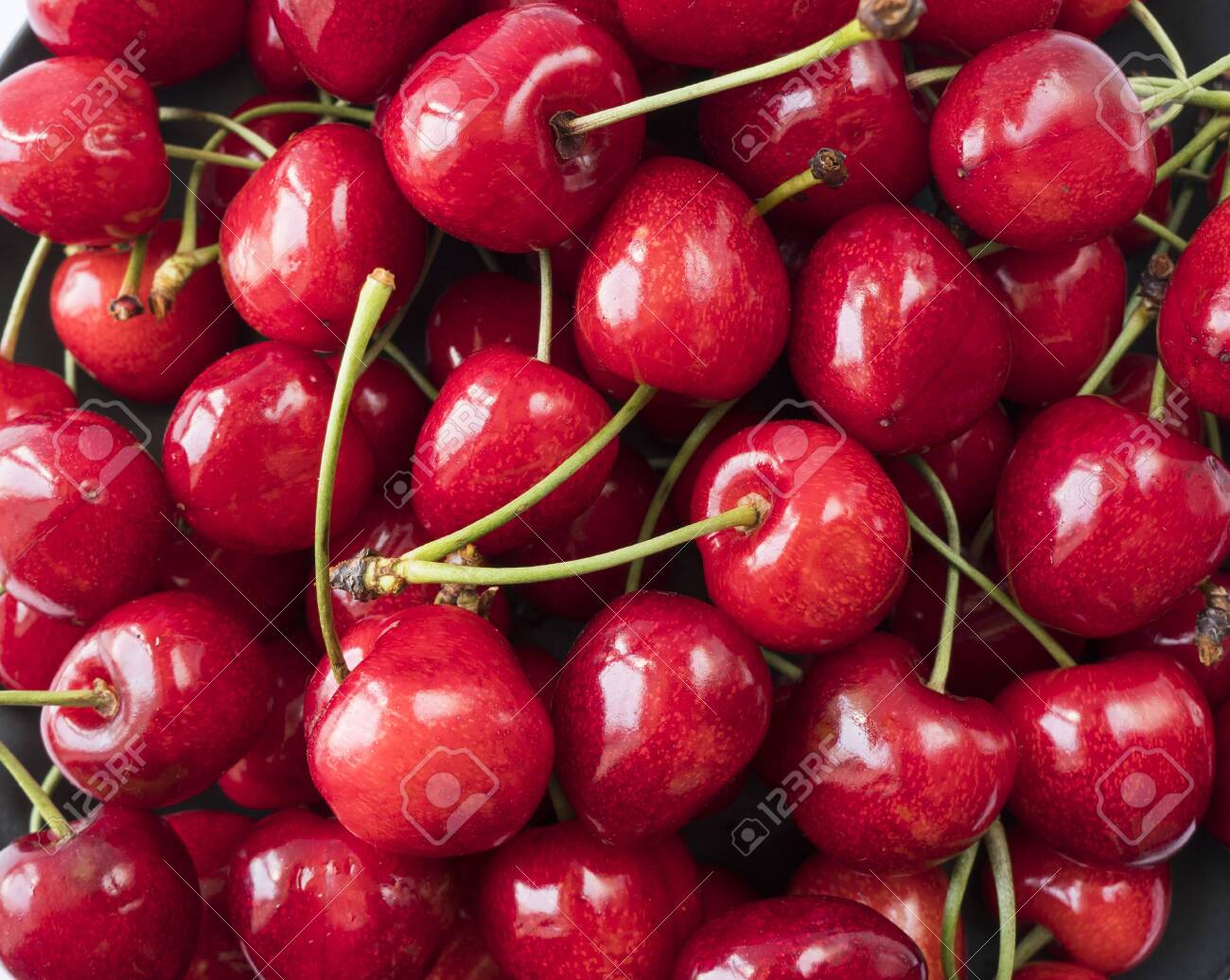 Fresh red cherries. Texture cherries fruits close up. Cherry fruit. Cherries with copy space for text. Top view. Background of cherries. - 125787631 Fresh red cherries. Texture cherries fruits close up. Cherry fruit. Cherries with copy space for text. Top view. Background of cherries. - 125787631