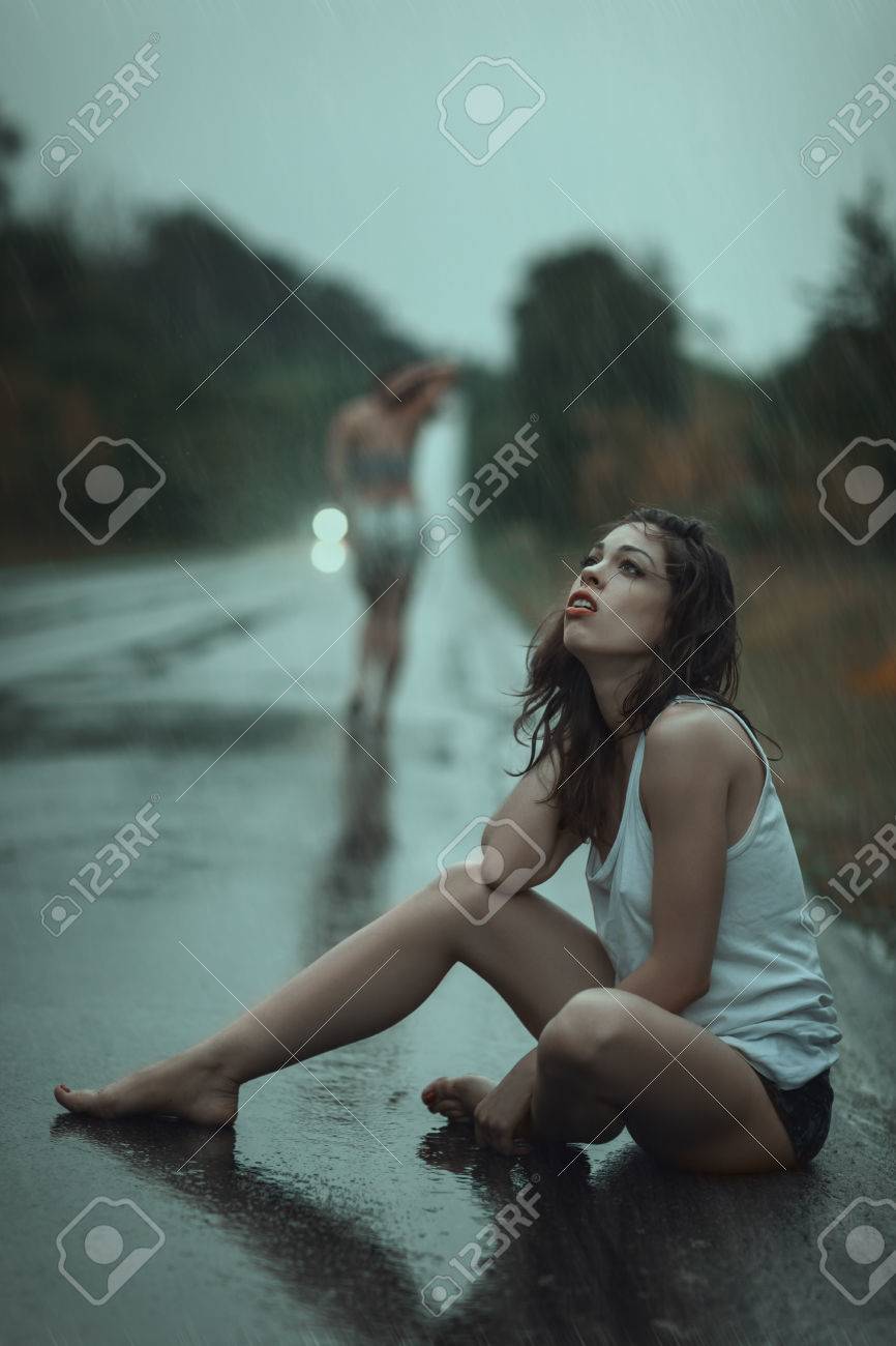 A Young Girl Crying Sitting On The Road In The Rain Stock Photo, Picture  and Royalty Free Image. Image 53725527., image size:866x1300