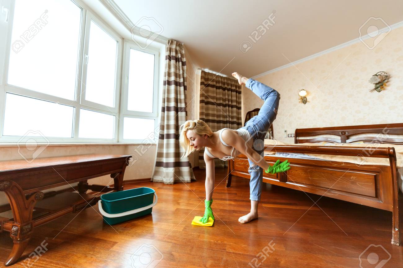 Woman Cleans Up The Apartment She Washes Floors And Does A Sports
