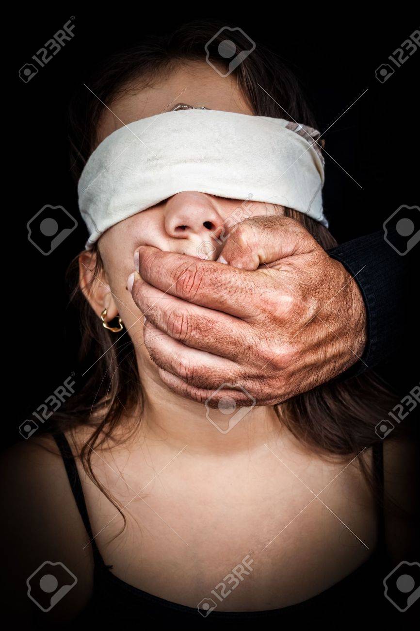 ハンカチで盲目に黒い背景に彼女の口を覆っている成人男性の手で小さな女の子 の写真素材 画像素材 Image