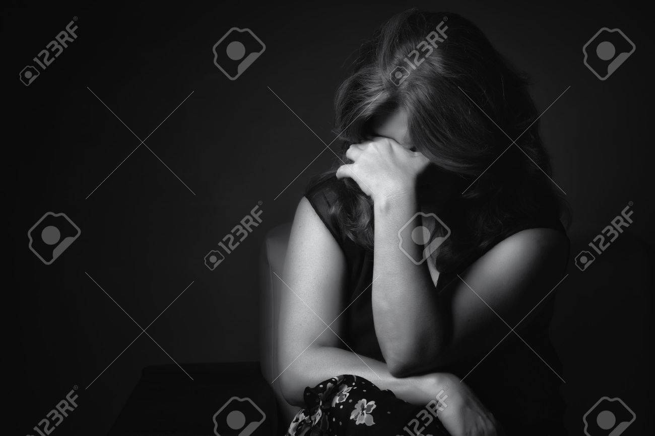 Black and white portrait of a crying sad and depressed woman with a dark background - 58557705 Black and white portrait of a crying sad and depressed woman with a dark background - 58557705