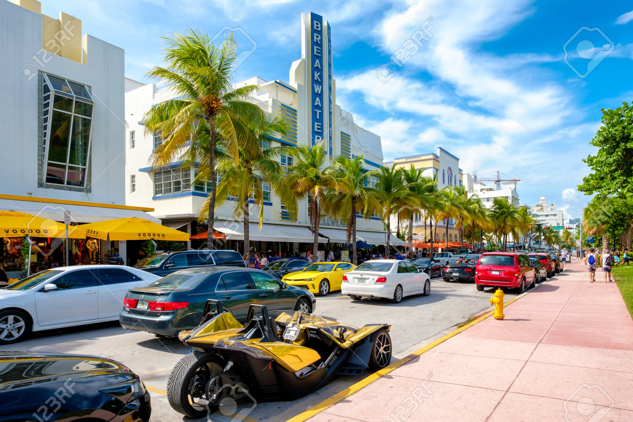 tourists and luxury cars at ocean drive a popular tourist