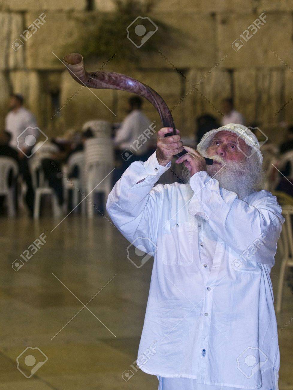 JERUSALEM - SEP 26 : Jew blowing in "Shofar" during the penitential prayers the "Selichot" , held on September 26 2011 in the "Wailing wall" in Jerusalem , Israel - 10707856 JERUSALEM - SEP 26 : Jew blowing in "Shofar" during the penitential prayers the "Selichot" , held on September 26 2011 in the "Wailing wall" in Jerusalem , Israel - 10707856
