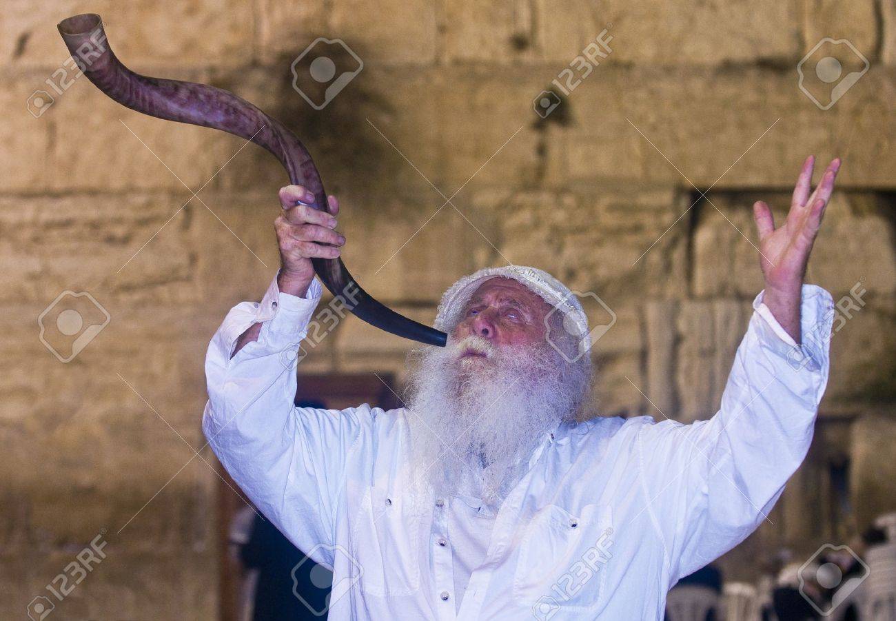 JERUSALEM - SEP 26 : Jew blowing in "Shofar" during the penitential prayers the "Selichot" , held on September 26 2011 in the "Wailing wall" in Jerusalem , Israel - 10707854 JERUSALEM - SEP 26 : Jew blowing in "Shofar" during the penitential prayers the "Selichot" , held on September 26 2011 in the "Wailing wall" in Jerusalem , Israel - 10707854