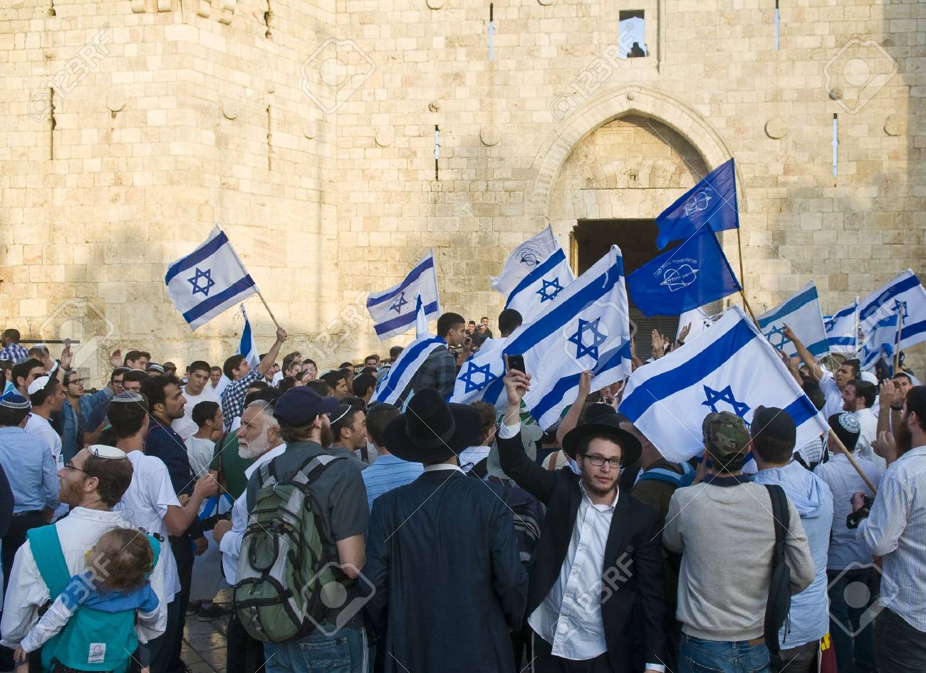 JERUSALEM - MAY 20 2012 : Right wing Israeli men dance on Jerusalem day in front of Damascus gate before marching throuh the Arab quarter of Jerusalem old city on May 20 2012 , Jerusalem day marks the anniversary of Israel capturing the eastern part of th - 13714884 JERUSALEM - MAY 20 2012 : Right wing Israeli men dance on Jerusalem day in front of Damascus gate before marching throuh the Arab quarter of Jerusalem old city on May 20 2012 , Jerusalem day marks the anniversary of Israel capturing the eastern part of th - 13714884