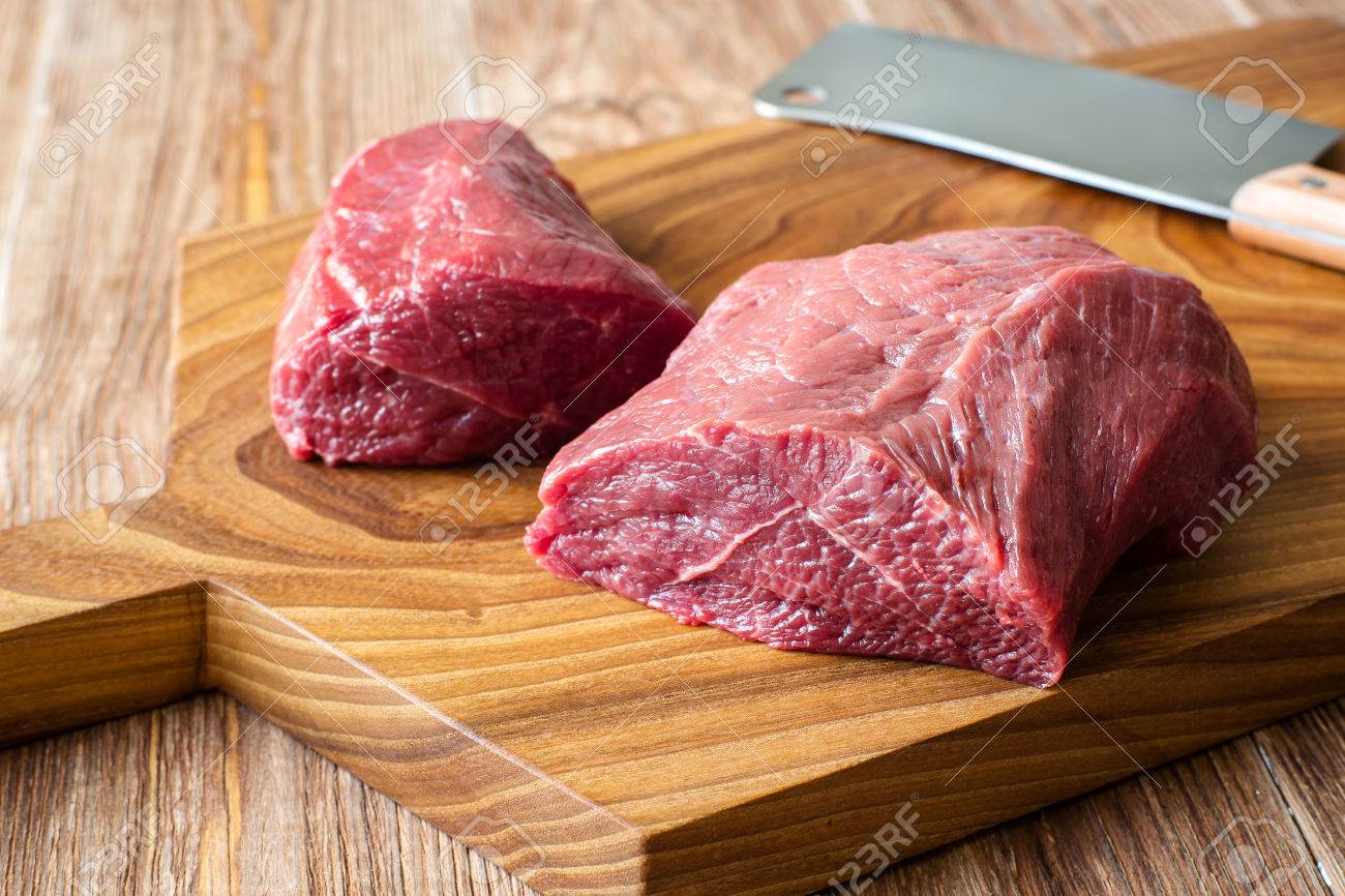 Fresh Meat On Chopping Board With Knife. Raw Meat. Two Peece Of Beef On  Wooden Table Stock Photo, Picture and Royalty Free Image. Image 60539396.