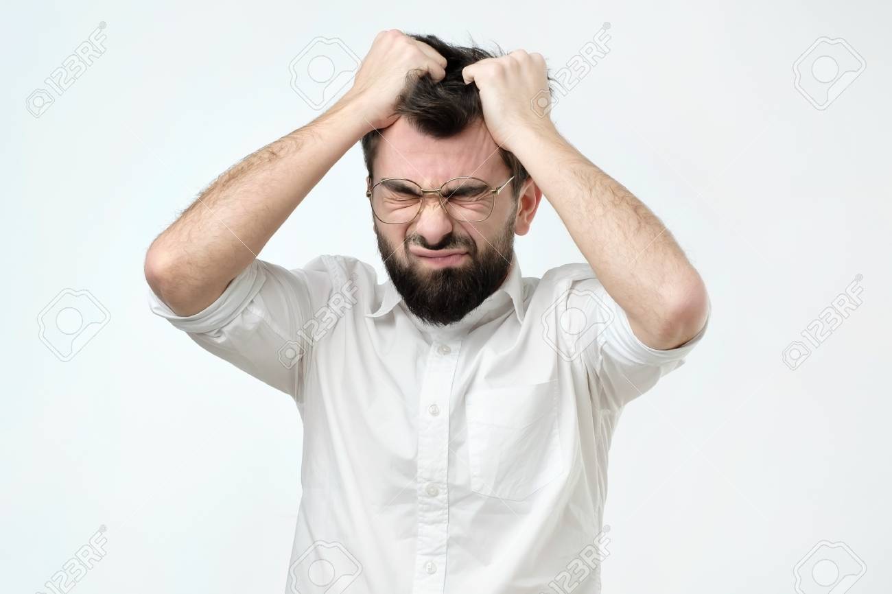 Enraged Young Businessman Pulling His Hair Out For Exasperation Stock Photo Picture And Royalty Free Image Image