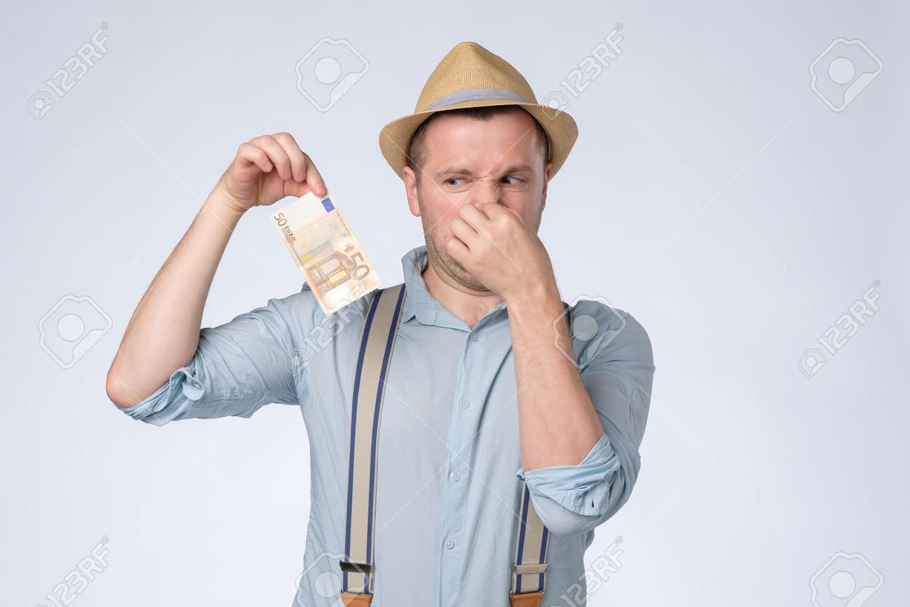 Young Man Smelling Something Stinky And Disgusting From Money. Stock Photo,  Picture and Royalty Free Image. Image 172473256., image size:1300x867