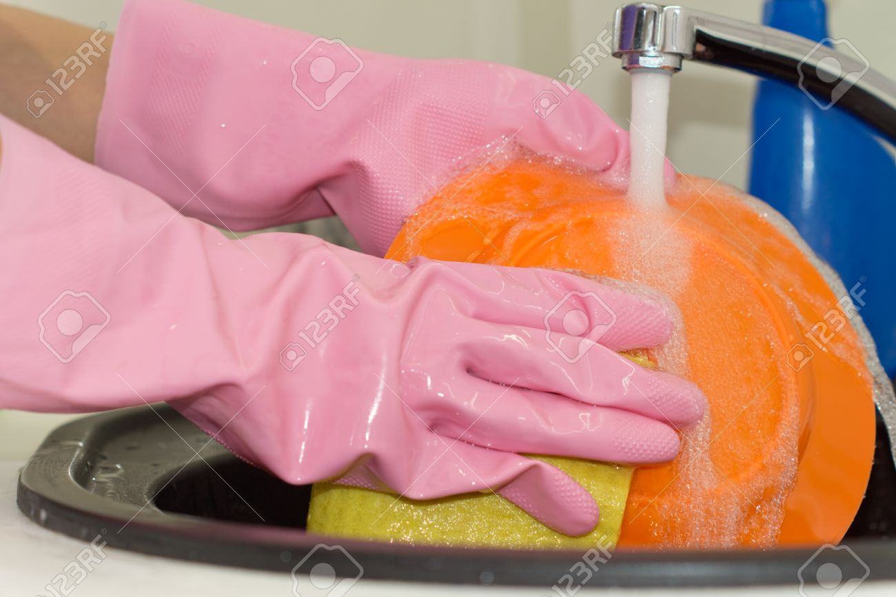 Kitchen Sink With Clean Dishes woman cleaning dishes in a kitchen sink rinsing off a bright Kitchen Sink With Clean Dishes woman cleaning dishes in a kitchen sink rinsing off a bright