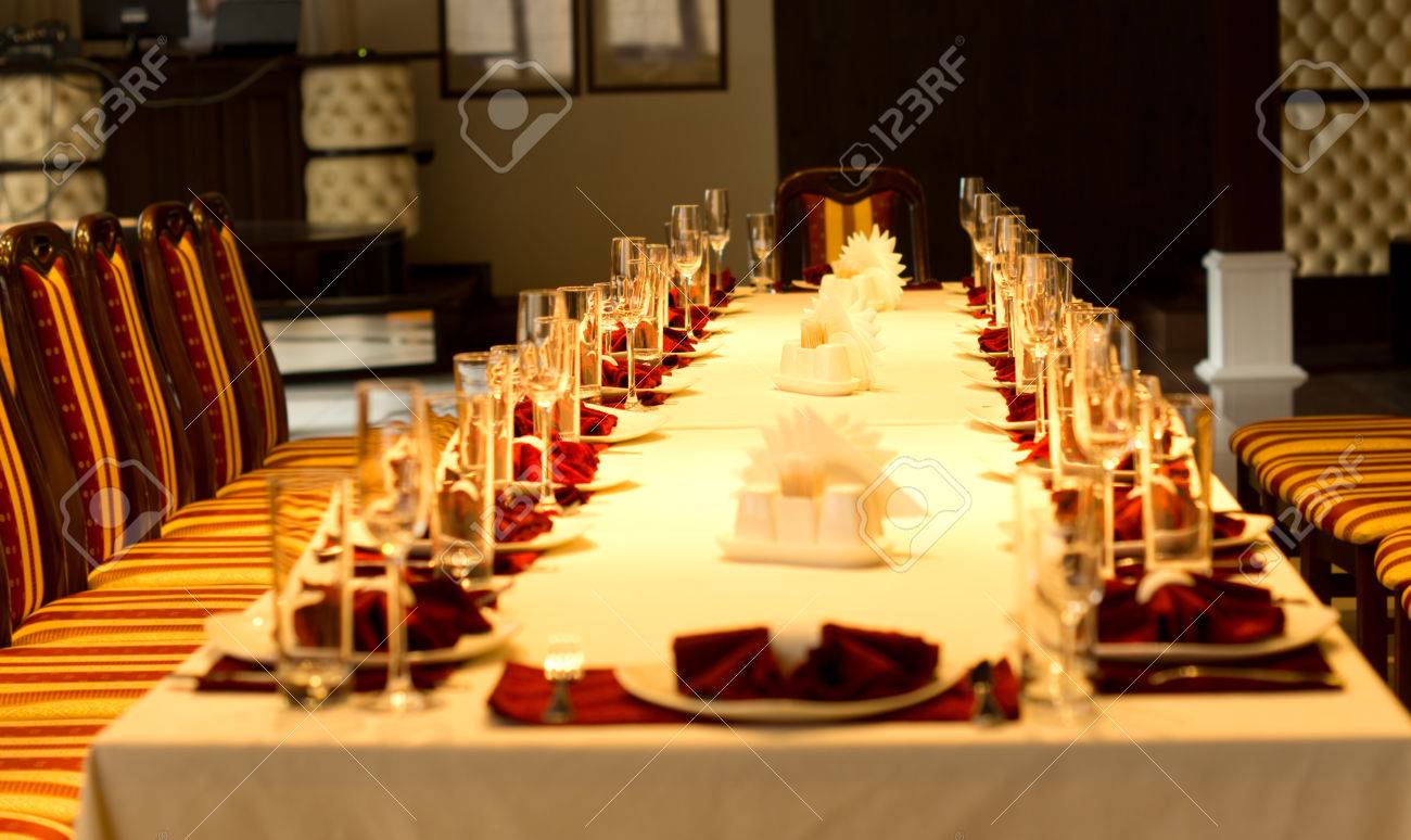 Elegant Formal Table Set With Red Linen Accents Stylish Glassware Silverware And Centerpieces For A Party Reception Or Festive Celebration View Down The Length Stock Photo Picture And Royalty Free Image