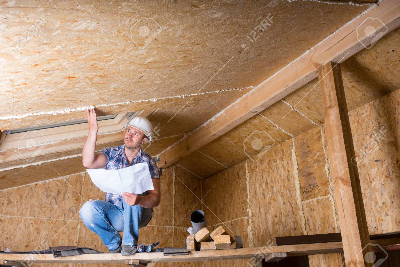 Male Construction Worker Builder Wearing White Hard Hat Crouching