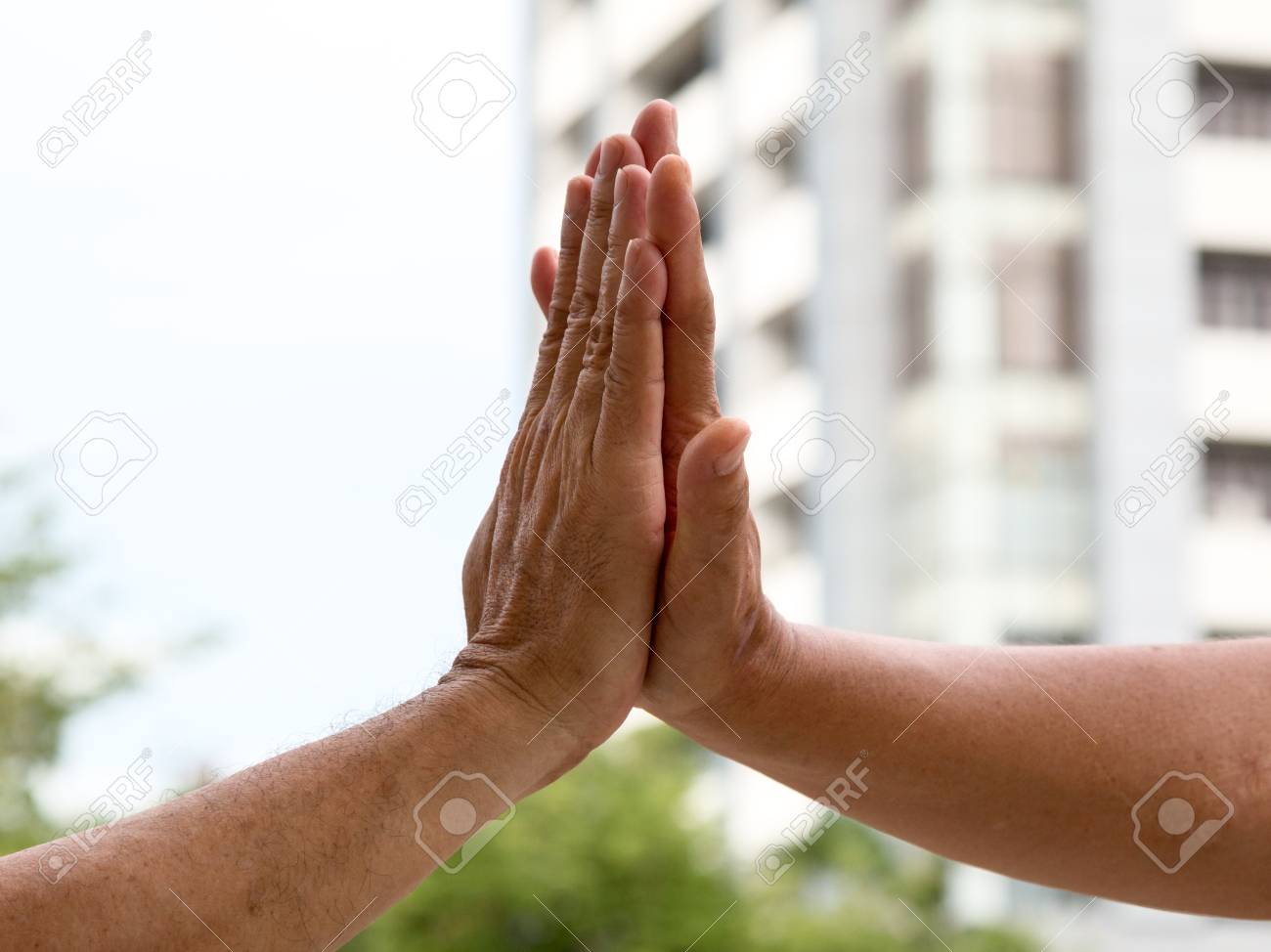 close up of hand clap of men giving hi five hand stock photo