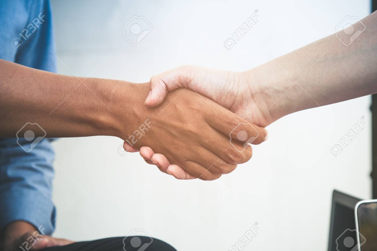 close up of two business man do hand shaking after acception the