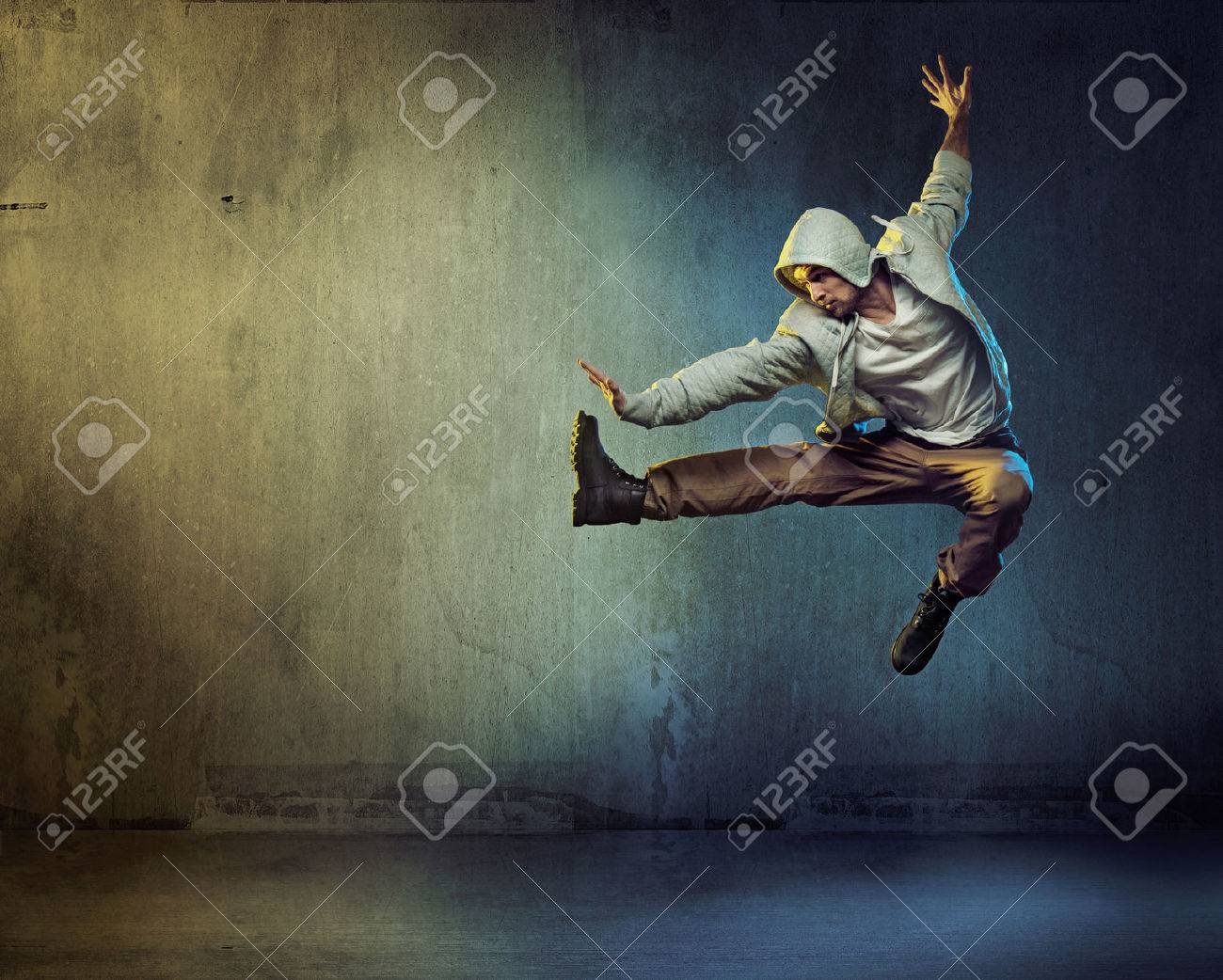 Athletic dancer in a super jumping pose - 53140584 Athletic dancer in a super jumping pose - 53140584