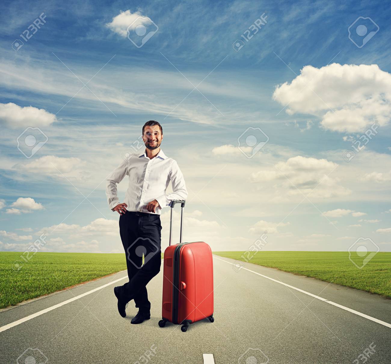 道をスーツケースを持って立っている幸せな男 の写真素材 画像素材 Image