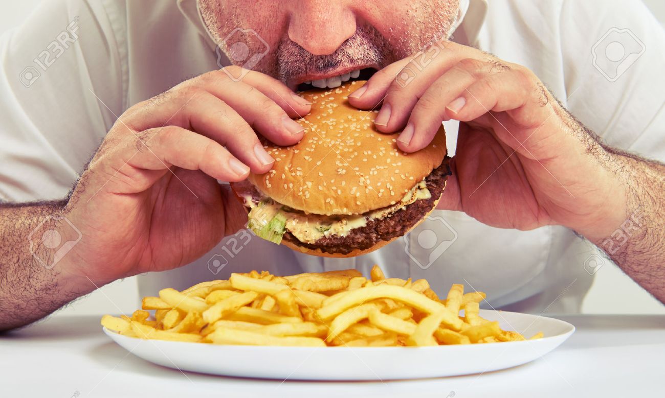close up photo of man eating burger and french fries - 40300796 close up photo of man eating burger and french fries - 40300796