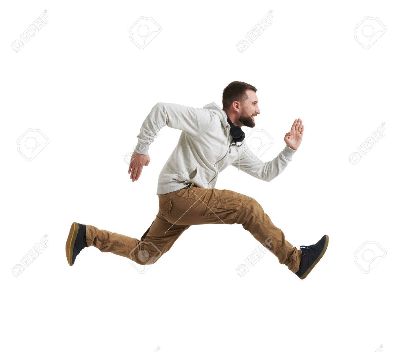 Young bearded man in casual clothes is shot in mid-air jump isolated over white background - 60221779 Young bearded man in casual clothes is shot in mid-air jump isolated over white background - 60221779