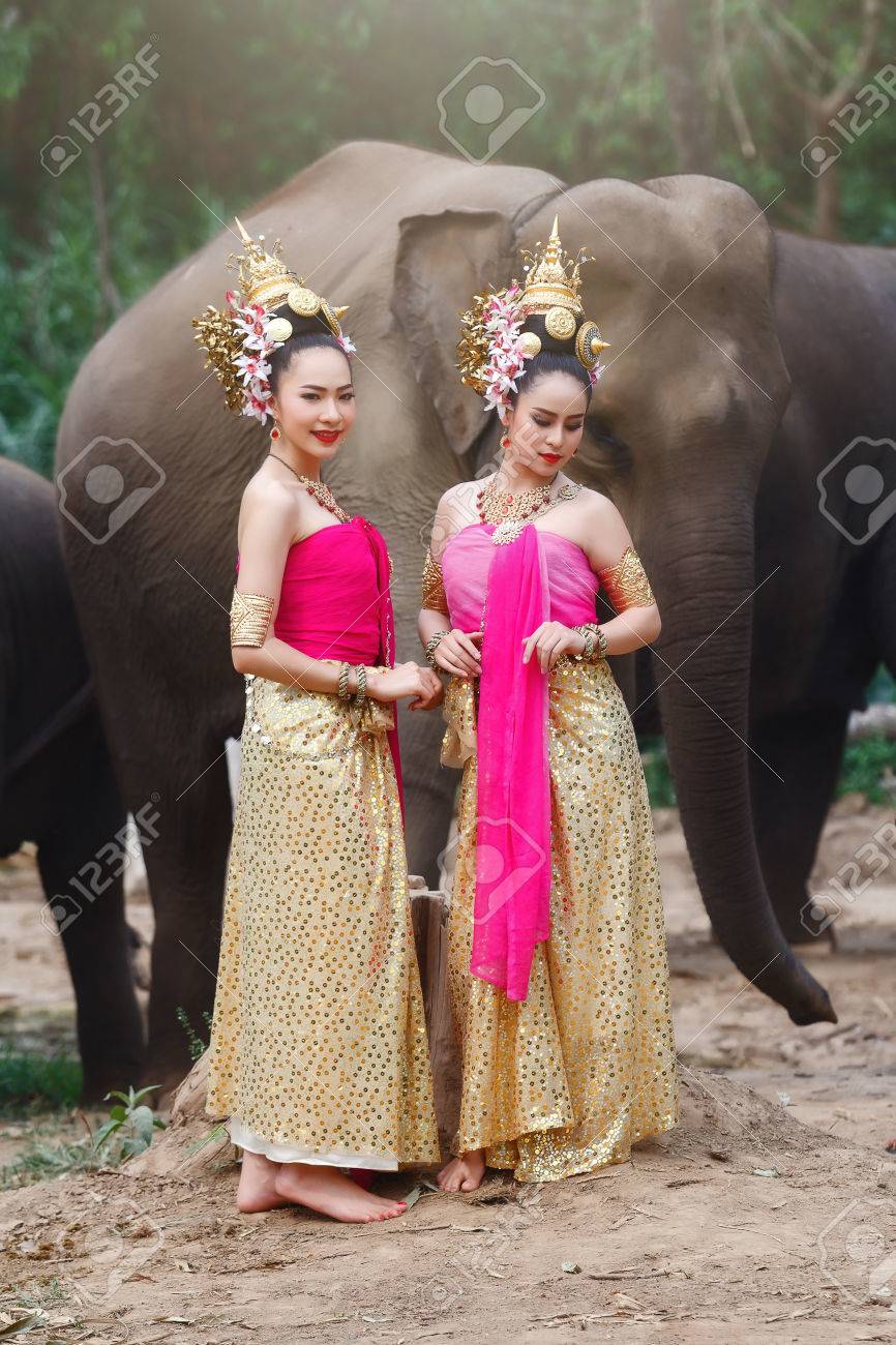 Pretty Thai Girls In Traditional Thai Costumes With Elephants Stock Photo,  Picture and Royalty Free Image. Image 80192838., image size:866x1300