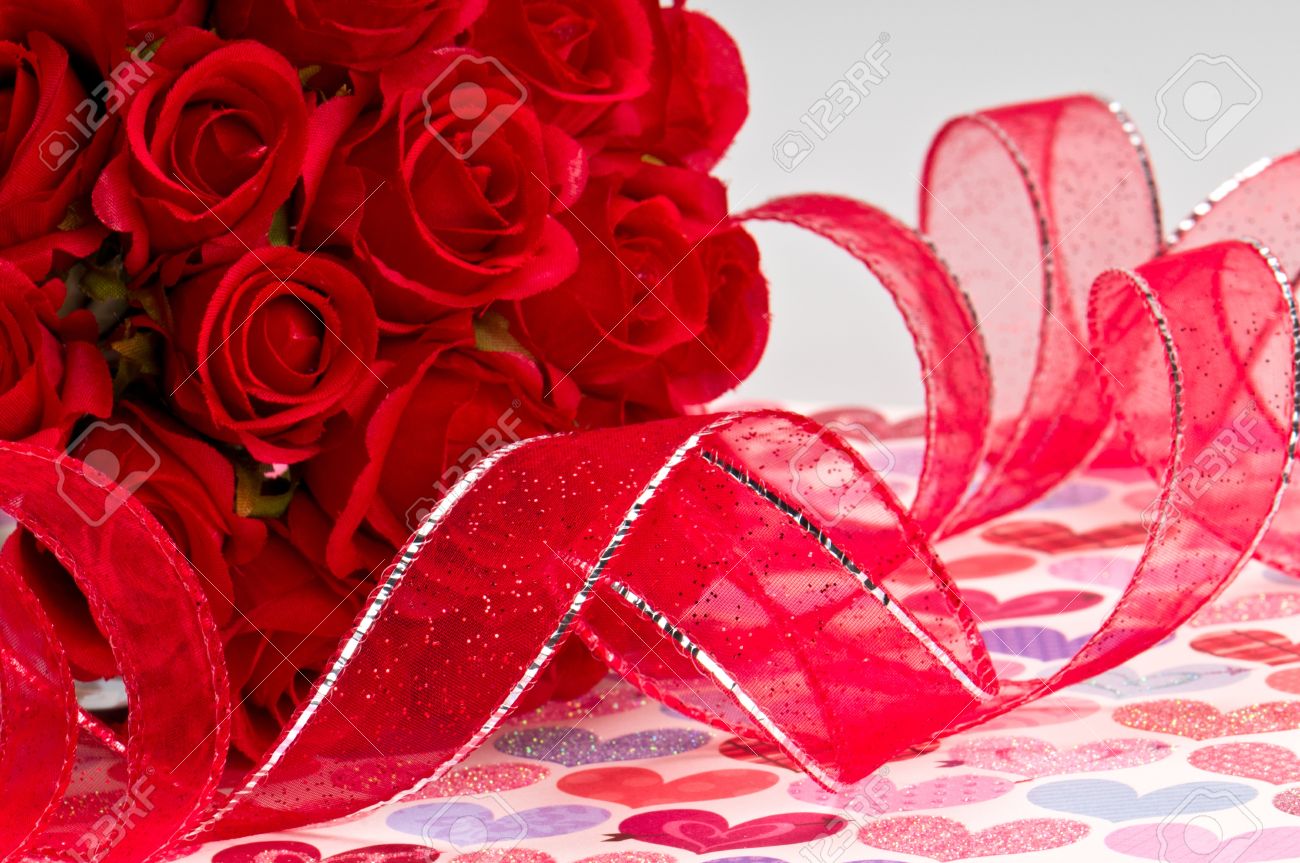 close up of red roses and red ribbon for valentines day stock photo