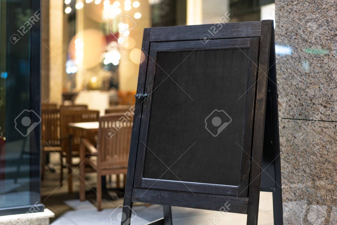 Close up of black sandwich board next to restaurant. - 106925137 Close up of black sandwich board next to restaurant. - 106925137